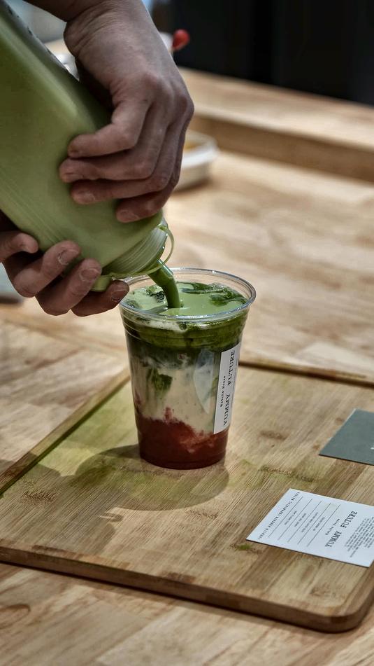Matcha poured over strawberry at the bar