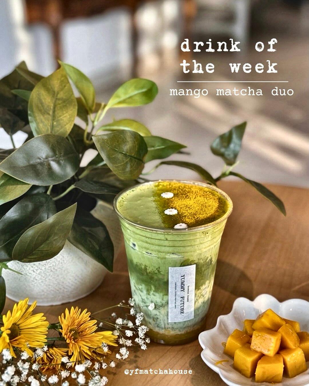 A Yummy Future matcha on the counter under the drink-of-the-week board